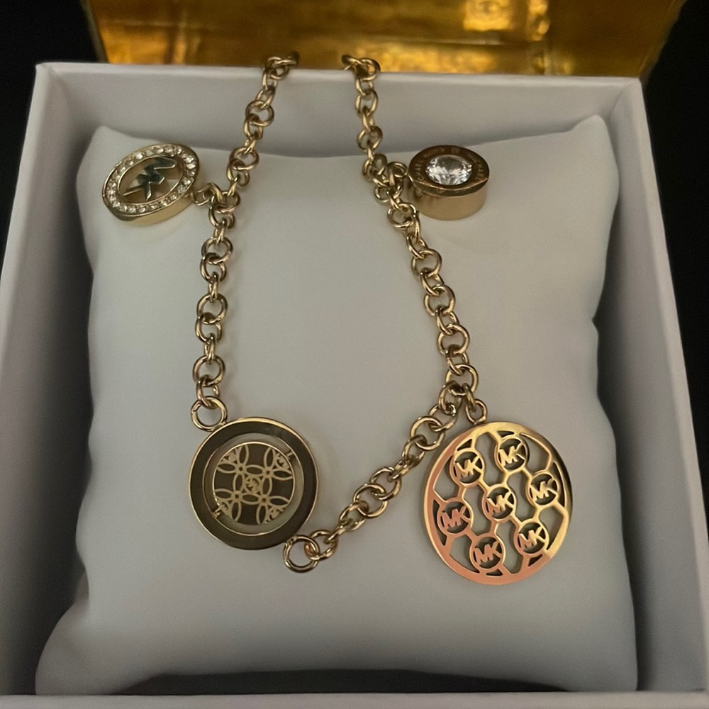 Michael Kors gold flip glitz 4 charms bracelet.